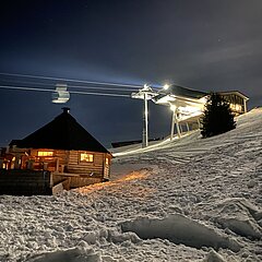 Snow-covered Saanersloch mountain station at night.
